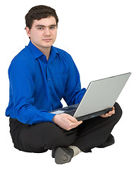 Image showing Businessman sits on a floor with the laptop