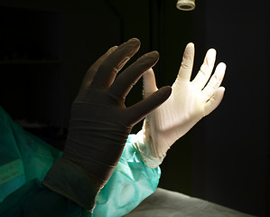 Image showing Surgeon holding up hands in protective gloves