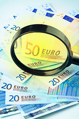 Image showing Euro currency under a magnifying glass