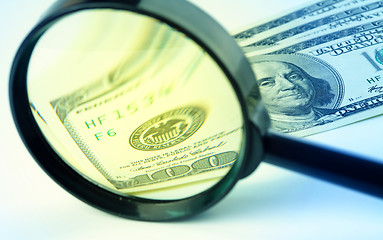 Image showing Dollars under a magnifying glass