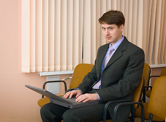 Image showing Person in a suit with the laptop