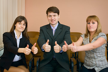 Image showing Team of businessmen show thumb up