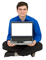 Image showing Guy sits on a floor with the laptop