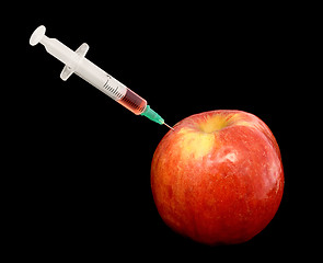 Image showing Red apple with syringe on black