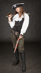 Image showing Beautiful girl - pirate with sabre and pistol