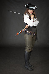 Image showing Girl - pirate with sabre and pistol on a black