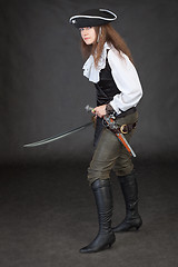 Image showing Pirate girl with pistol and saber