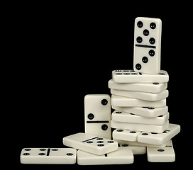 Image showing Heap of white dominoes isolated on black