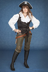 Image showing Beautiful girl - pirate stand on blue background