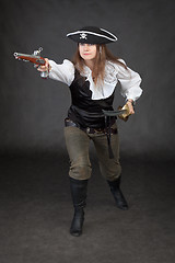 Image showing Pirate girl rush to the attack with gun