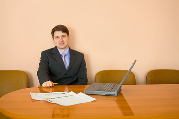 Image showing Businessman at a table with laptop