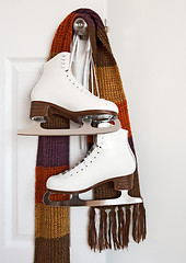 Image showing Figure skates and colourful scarf