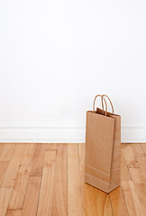 Image showing Paper bag on wooden floor