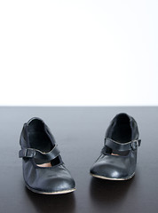 Image showing Black shoes on wooden surface