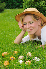 Image showing Young woman and easter eggs on the grass - Easter time