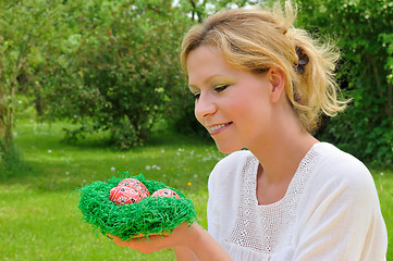 Image showing Young woman and easter eggs