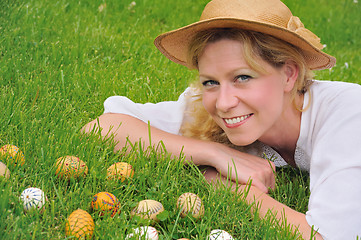 Image showing Young woman and easter eggs on the grass - Easter time