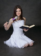 Image showing Girl - fairy in a white dress with magic wand and book