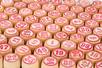 Image showing Wooden counters for bingo with red numbers