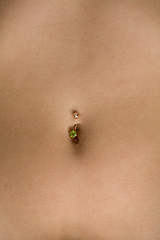 Image showing Female tummy with a navel and piercing