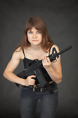 Image showing The beautiful young sexual woman with a rifle