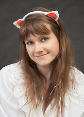 Image showing Smiling beautiful girl in white chemise and with glamour ears