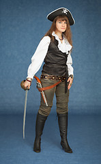 Image showing Pirate girl with sabre on blue background