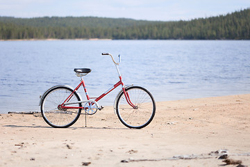 Image showing Old red bicycle photographed on beach