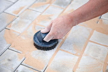 Image showing Installation of brick platform - smoothing-out with sand