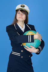 Image showing Girl in uniform embrace globe