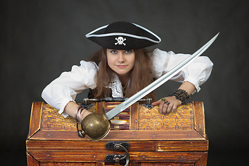 Image showing Woman pirate with a sabre and treasures