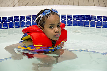 Image showing A young boy soaking in a hot tub