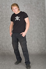 Image showing Young guy in a T-shirt with piracy symbolics