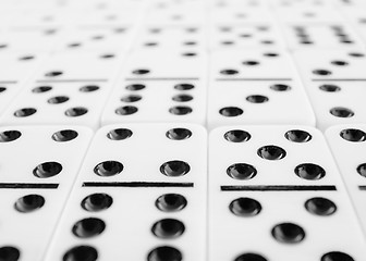 Image showing Surface covered with gray dominoes bones