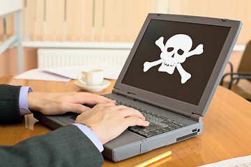 Image showing Laptop with pirate software