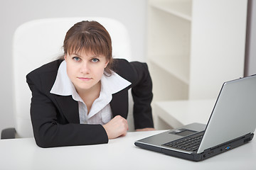 Image showing Resolutely woman - managing director sits at table with laptop