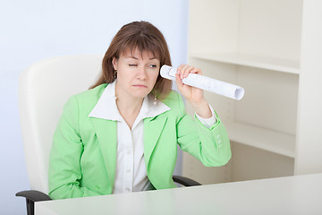 Image showing Ridiculous woman looks through drawing curtailed by tubule