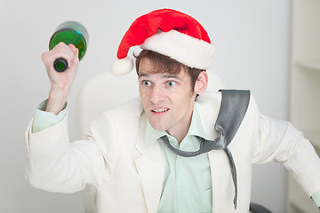 Image showing Young guy in christmas hat brawls with bottle in hand