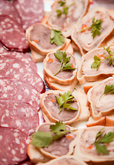 Image showing Sausage and sandwiches with meat on plate