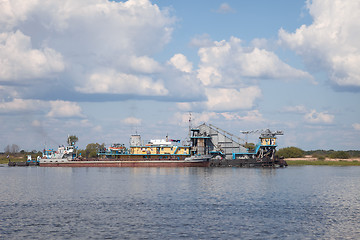 Image showing Floating construction from old ships on river