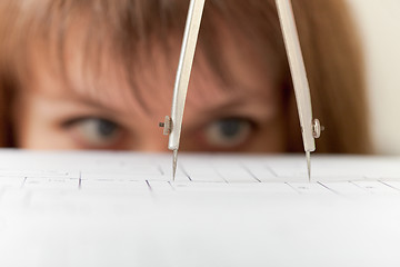 Image showing Compasses and drawing close up on face background