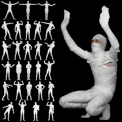 Image showing Collection of bandaged mummies isolated on black background