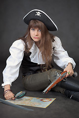 Image showing Woman in costume of pirate with sea map and magnifier glass