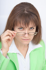 Image showing Serious woman - teacher looks at us over glasses