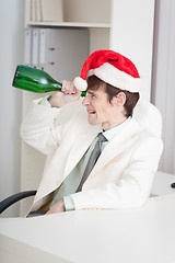 Image showing Businessman celebrates Christmases at office on workplace