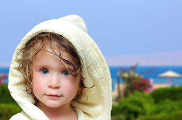 Image showing cute girl in bathrobe on beach