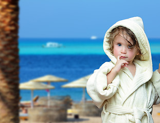 Image showing cute girl in bathrobe on beach