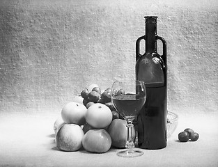 Image showing Black and white still-life with wine and fruit on sacking