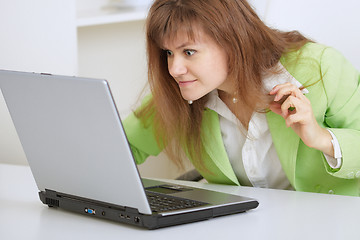 Image showing Girl is angry with the laptop and Internet