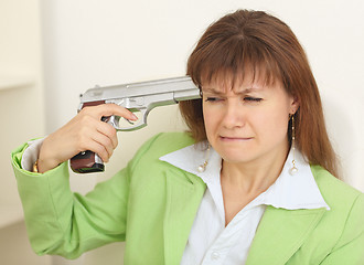 Image showing Woman - suicide shoots to itself at head from a pistol